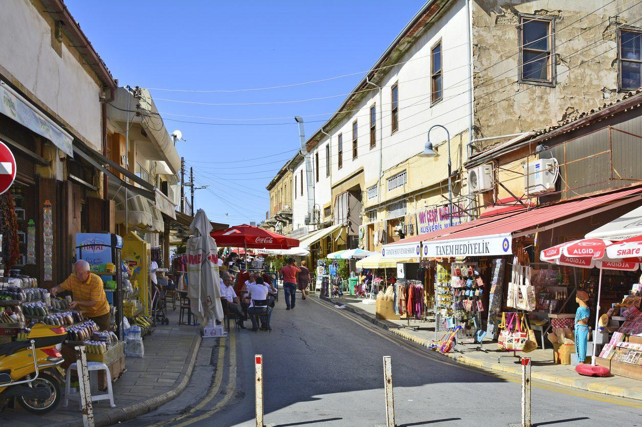 A market street in North Cyprus, with shopfronts, awnings and souvenir stalls